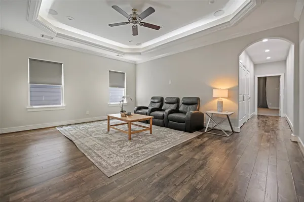 a living room with furniture and a wooden floor
