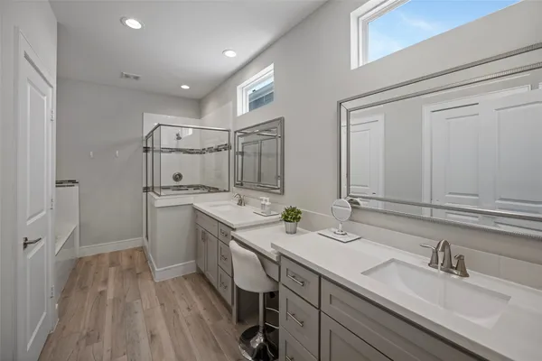 a bathroom with double vanity sink and a mirror