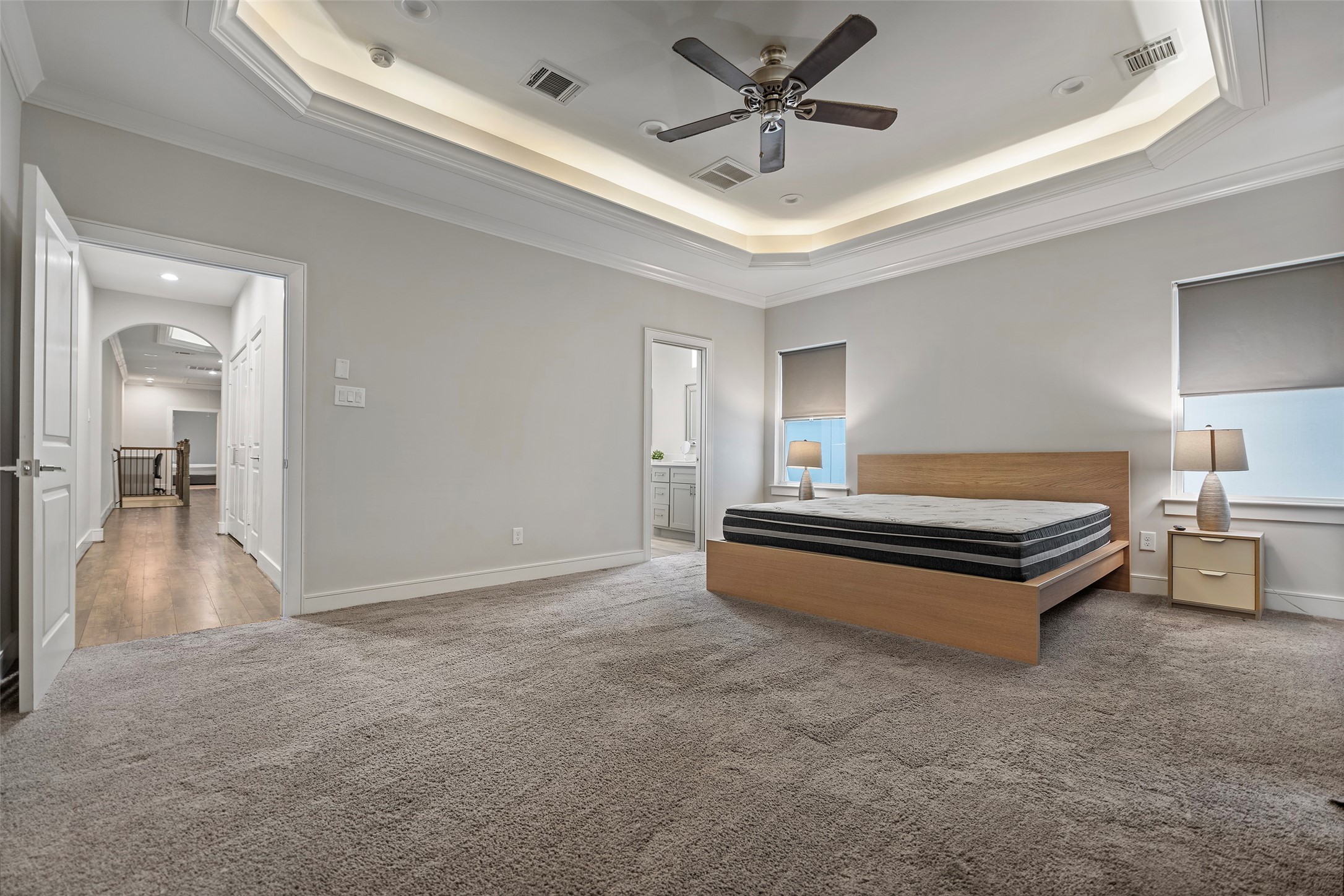 6533 Castlebay Drive Houston, TX 77092 - Photo 31 of 50 a spacious bedroom with a bed and a chandelier