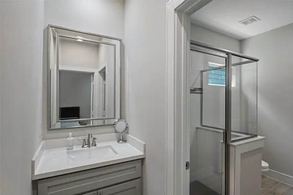 a bathroom with a sink mirror and vanity