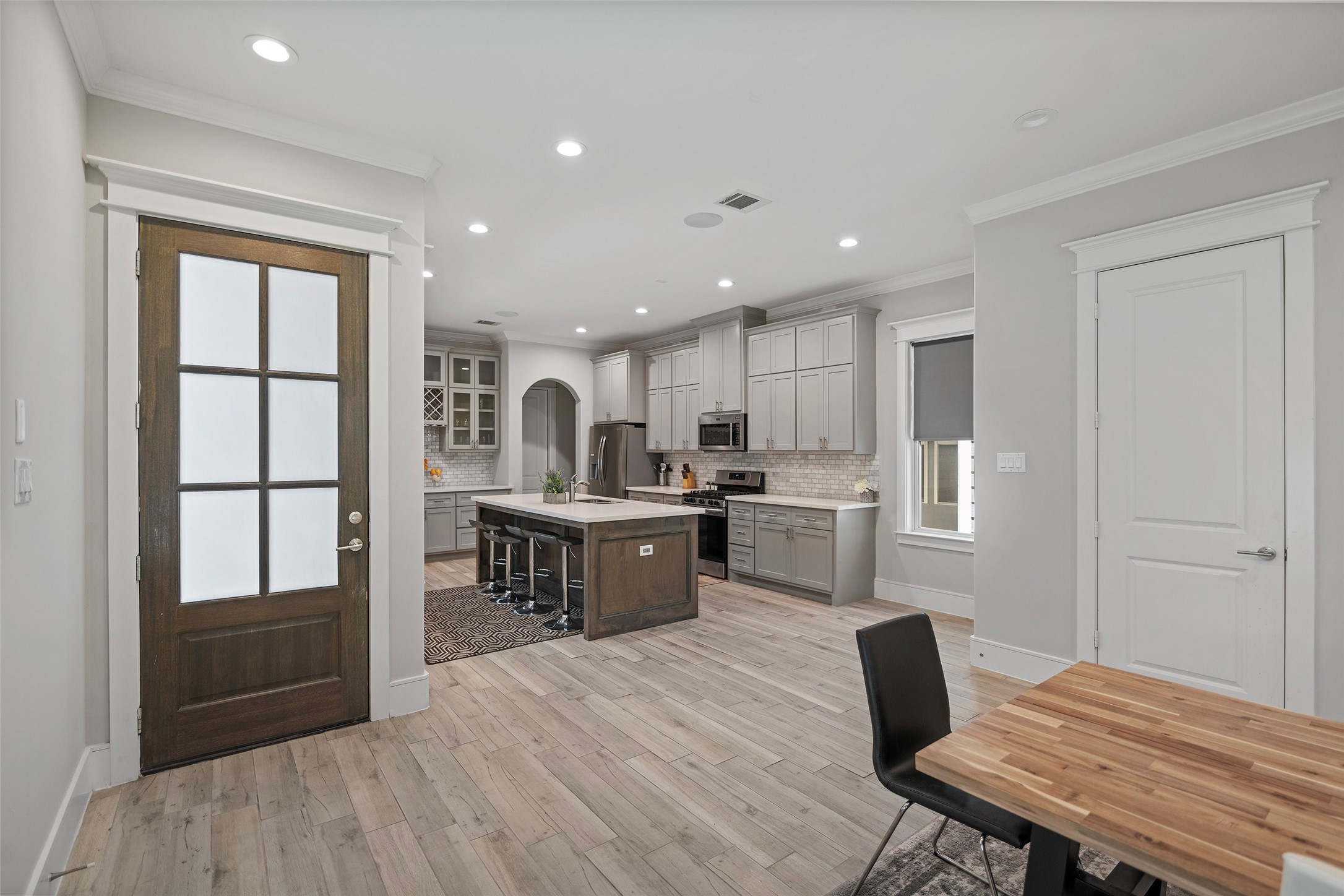 6533 Castlebay Drive Houston, TX 77092 - Photo 4 of 50 a kitchen with a table chairs refrigerator and microwave