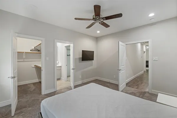 a bedroom with a bed and a television