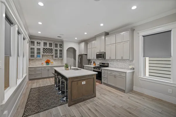 a kitchen with stainless steel appliances granite countertop a stove and a refrigerator