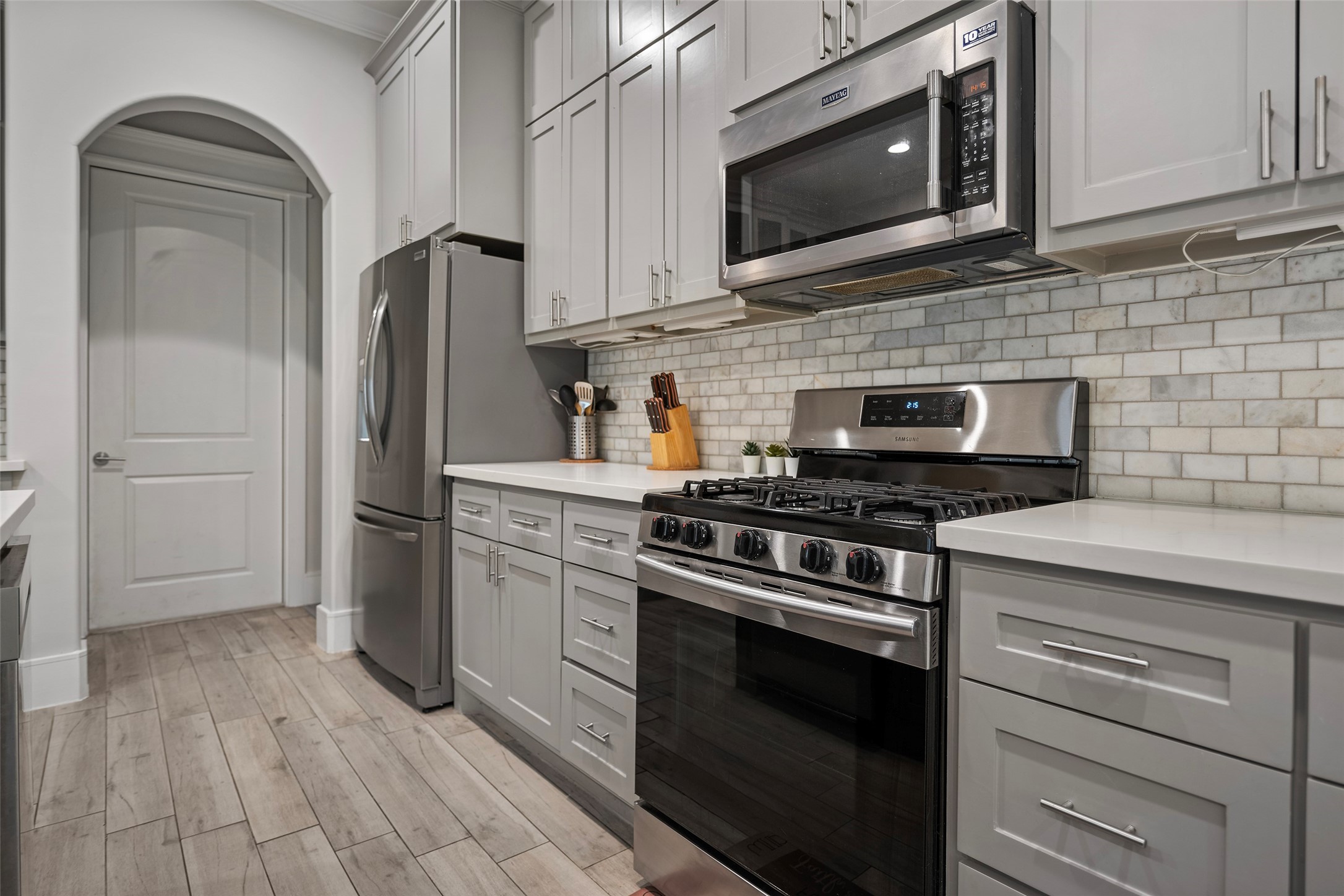 6533 Castlebay Drive Houston, TX 77092 - Photo 6 of 50 a kitchen with stainless steel appliances granite countertop a stove microwave and refrigerator