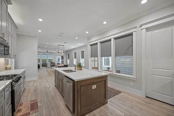 a kitchen with a stove a sink and a refrigerator