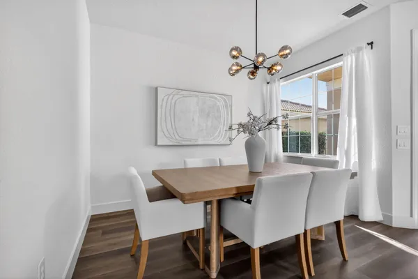 a living room with furniture potted plant and a lamp