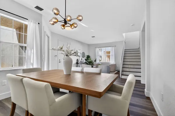 a living room with furniture kitchen view and a dining table