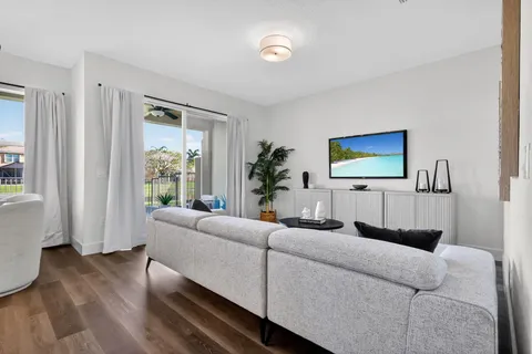 a kitchen with kitchen island granite countertop a sink cabinets and stainless steel appliances