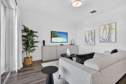 a living room with furniture and a wooden floor
