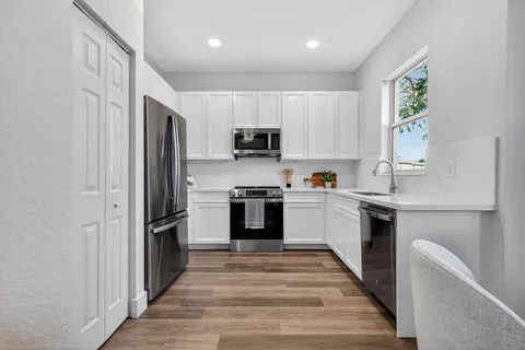 a view of an empty room with wooden floor