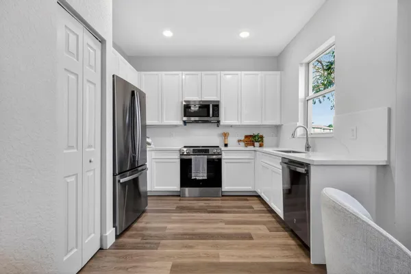 a view of an empty room with wooden floor