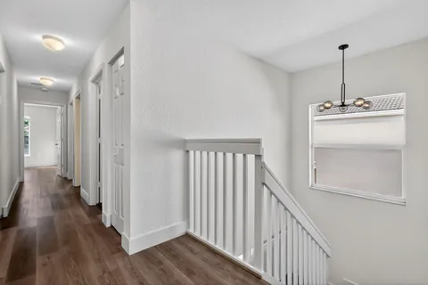 a bathroom with a tub a sink and a large mirror next to a window