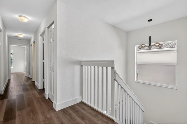 a bathroom with a tub a sink and a large mirror next to a window
