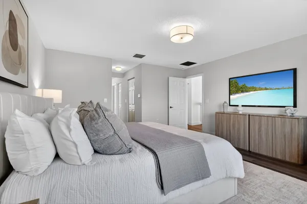 an aerial view of a city with lots of residential buildings ocean and mountain view in back