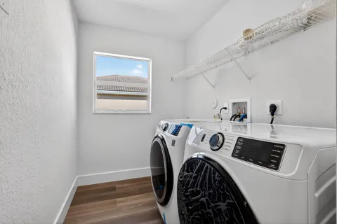 a front view of a house with a garden and trees