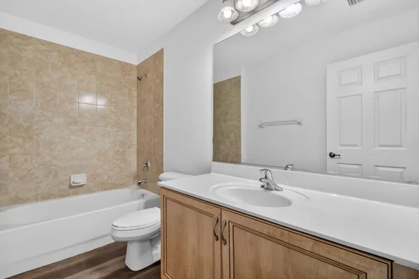 a view of a swimming pool and lounge chairs in back yard