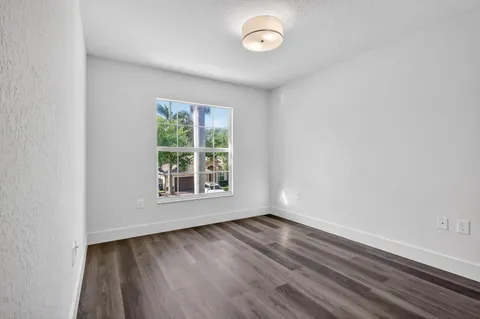 a view of a park with a fountain in front of a house