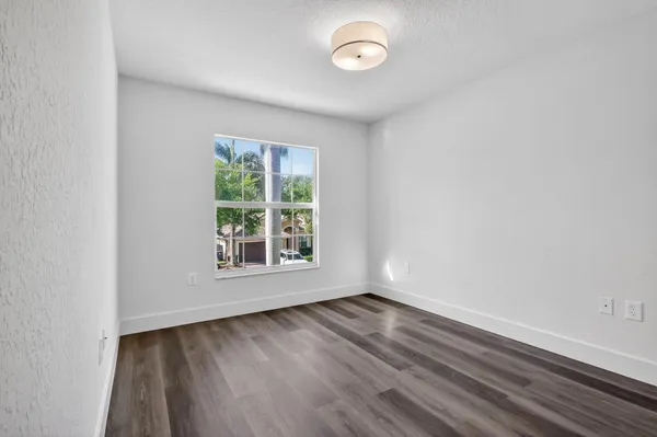 a view of a park with a fountain in front of a house