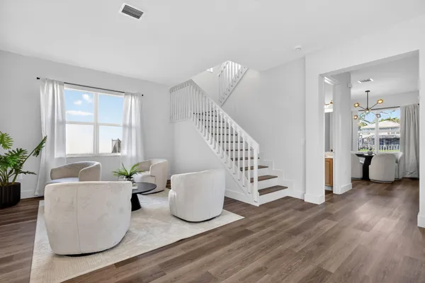 a living room with furniture and a potted plant