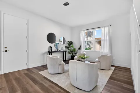 a view of a dining room with furniture window and wooden floor