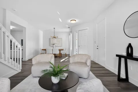 a view of a dining room with furniture and wooden floor