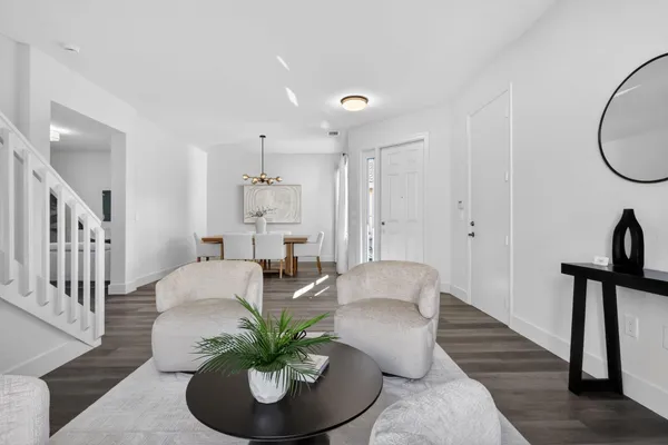 a view of a dining room with furniture and wooden floor