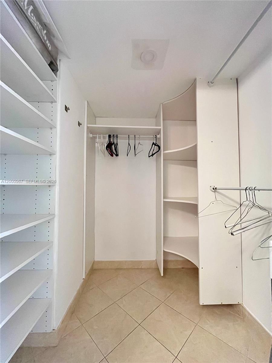 9511 Collins Avenue, Unit 811 Surfside, FL 33154 - Photo 14 of 29 a view of an empty walk in closet