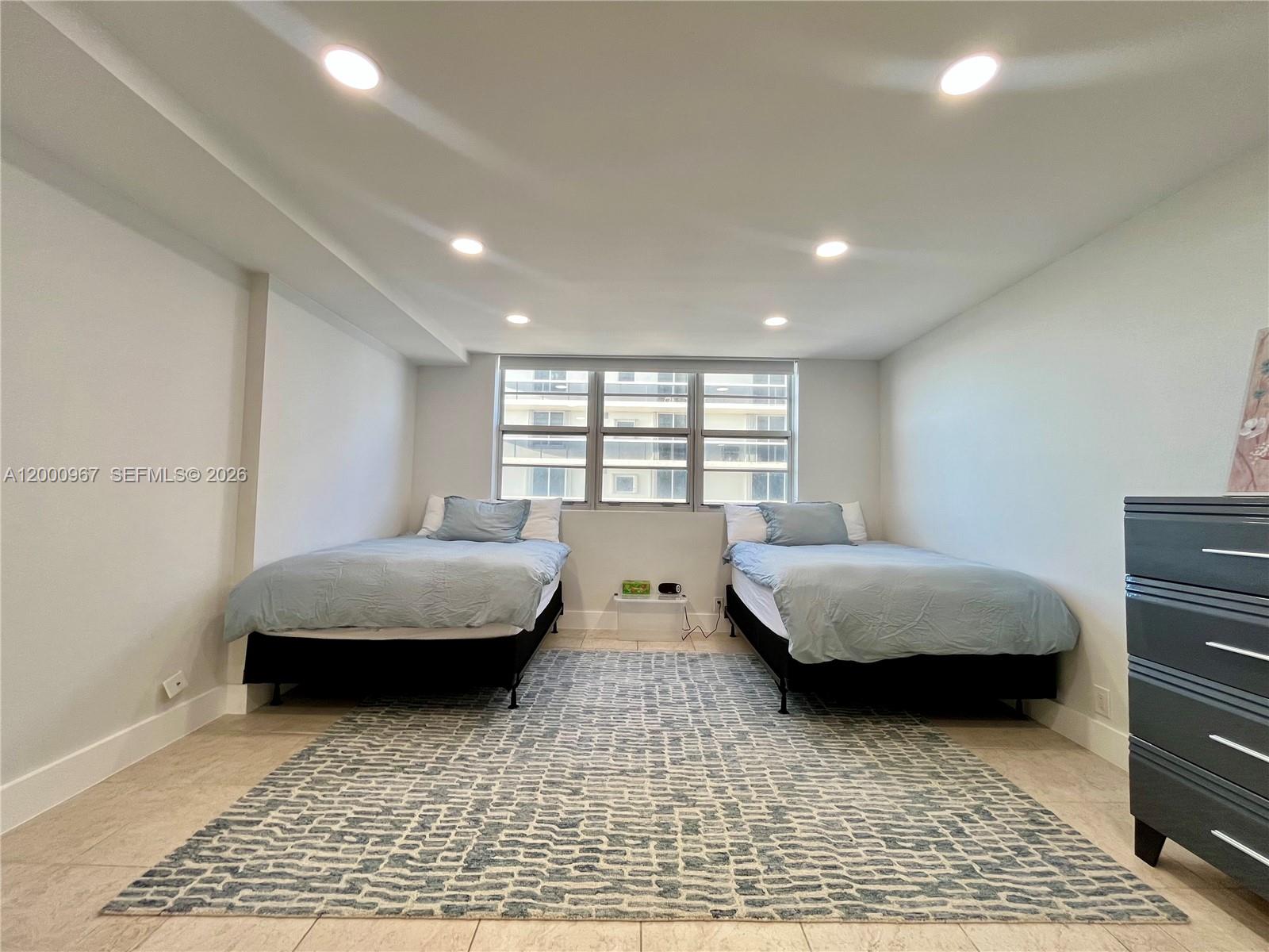 9511 Collins Avenue, Unit 811 Surfside, FL 33154 - Photo 15 of 29 a bedroom with double bed and a window