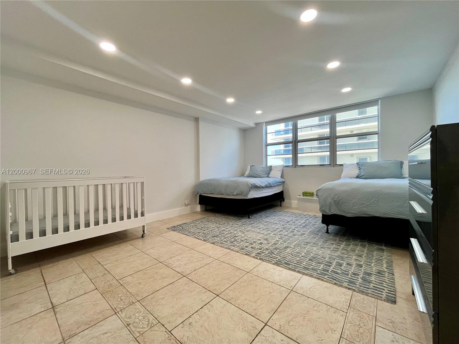 9511 Collins Avenue, Unit 811 Surfside, FL 33154 - Photo 16 of 29 a living room with furniture and a window