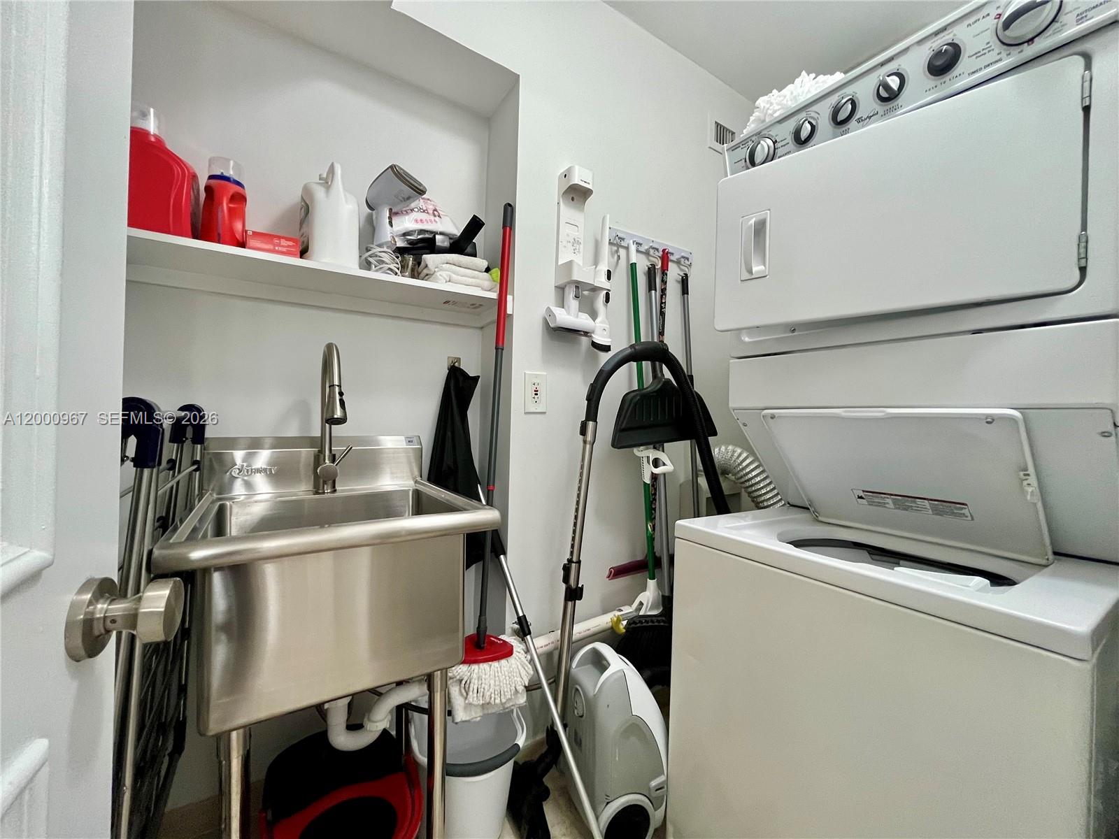 9511 Collins Avenue, Unit 811 Surfside, FL 33154 - Photo 19 of 29 a storage room with washer and dryer