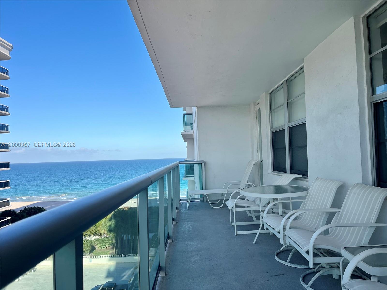 9511 Collins Avenue, Unit 811 Surfside, FL 33154 - Photo 2 of 29 a view of an chairs and table in the balcony