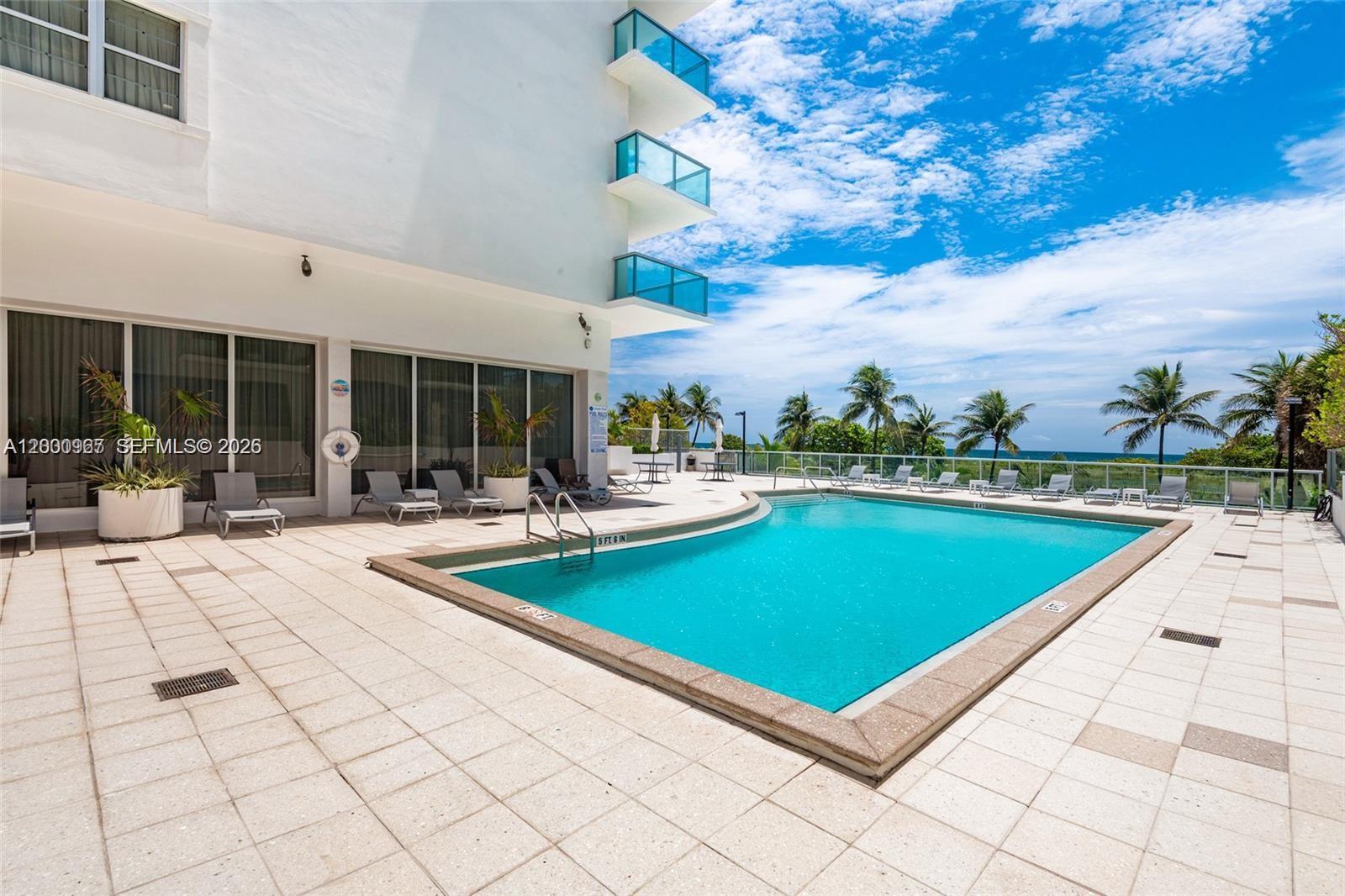 9511 Collins Avenue, Unit 811 Surfside, FL 33154 - Photo 23 of 29 a view of swimming pool with outdoor seating and plants