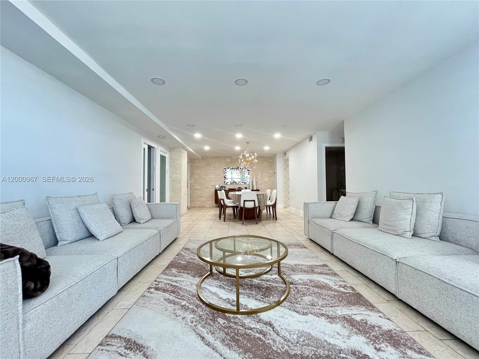 9511 Collins Avenue, Unit 811 Surfside, FL 33154 - Photo 3 of 29 a living room with furniture and a large window