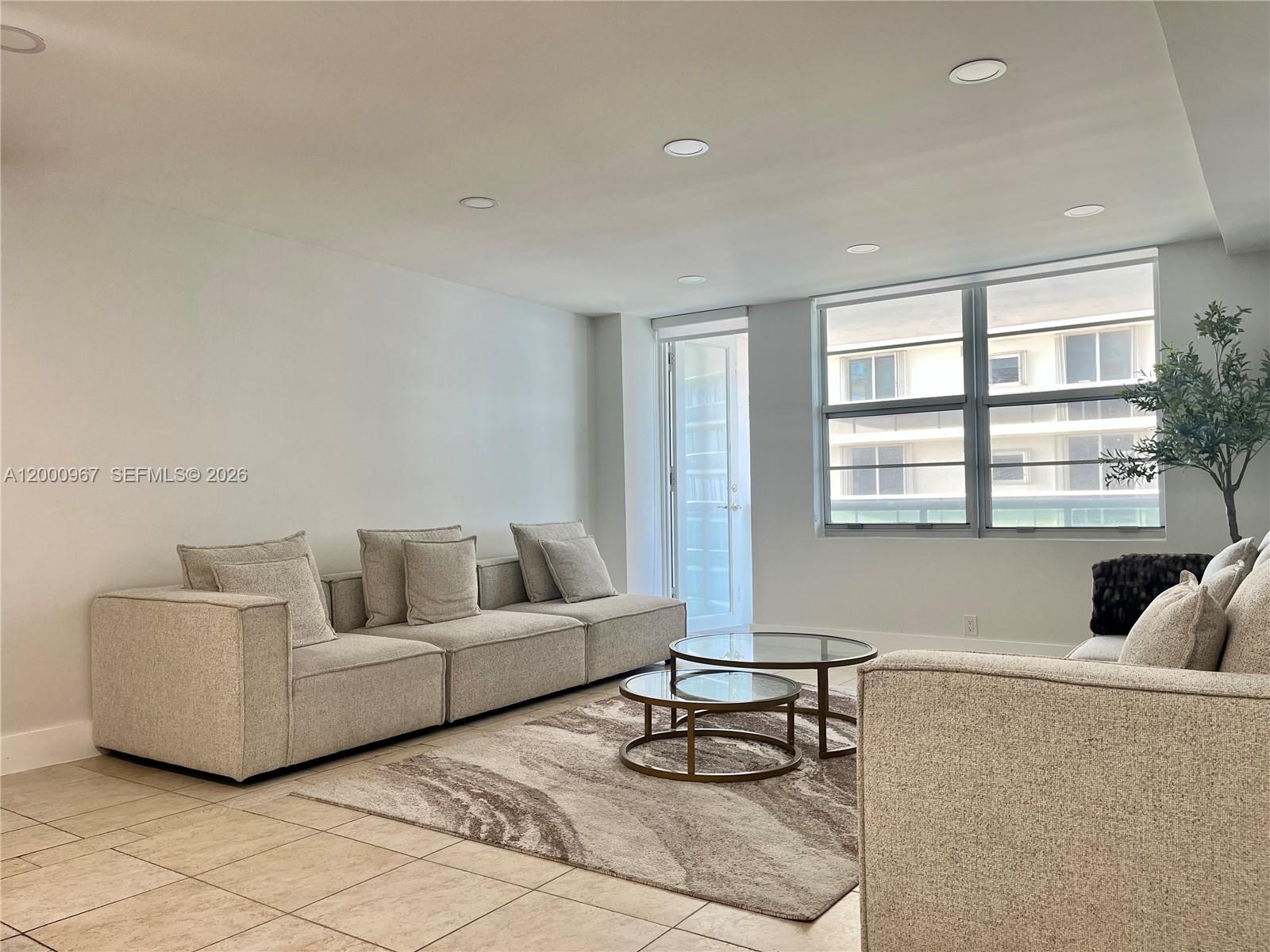 9511 Collins Avenue, Unit 811 Surfside, FL 33154 - Photo 5 of 29 a living room with furniture and a window
