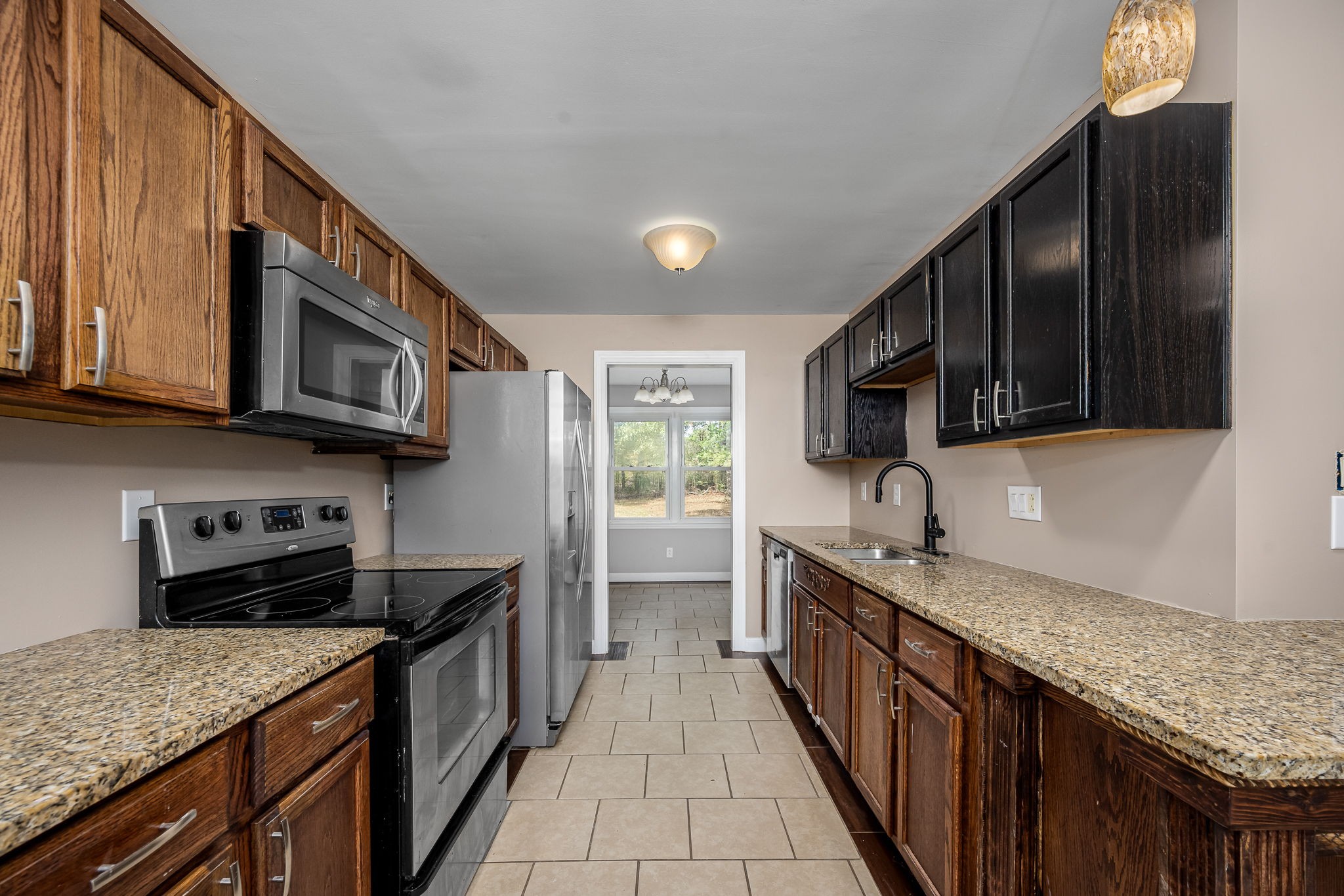 104 Dove Hollow Road Tullahoma, TN 37388 - Photo 14 of 37 a kitchen with stainless steel appliances granite countertop a sink stove and cabinets
