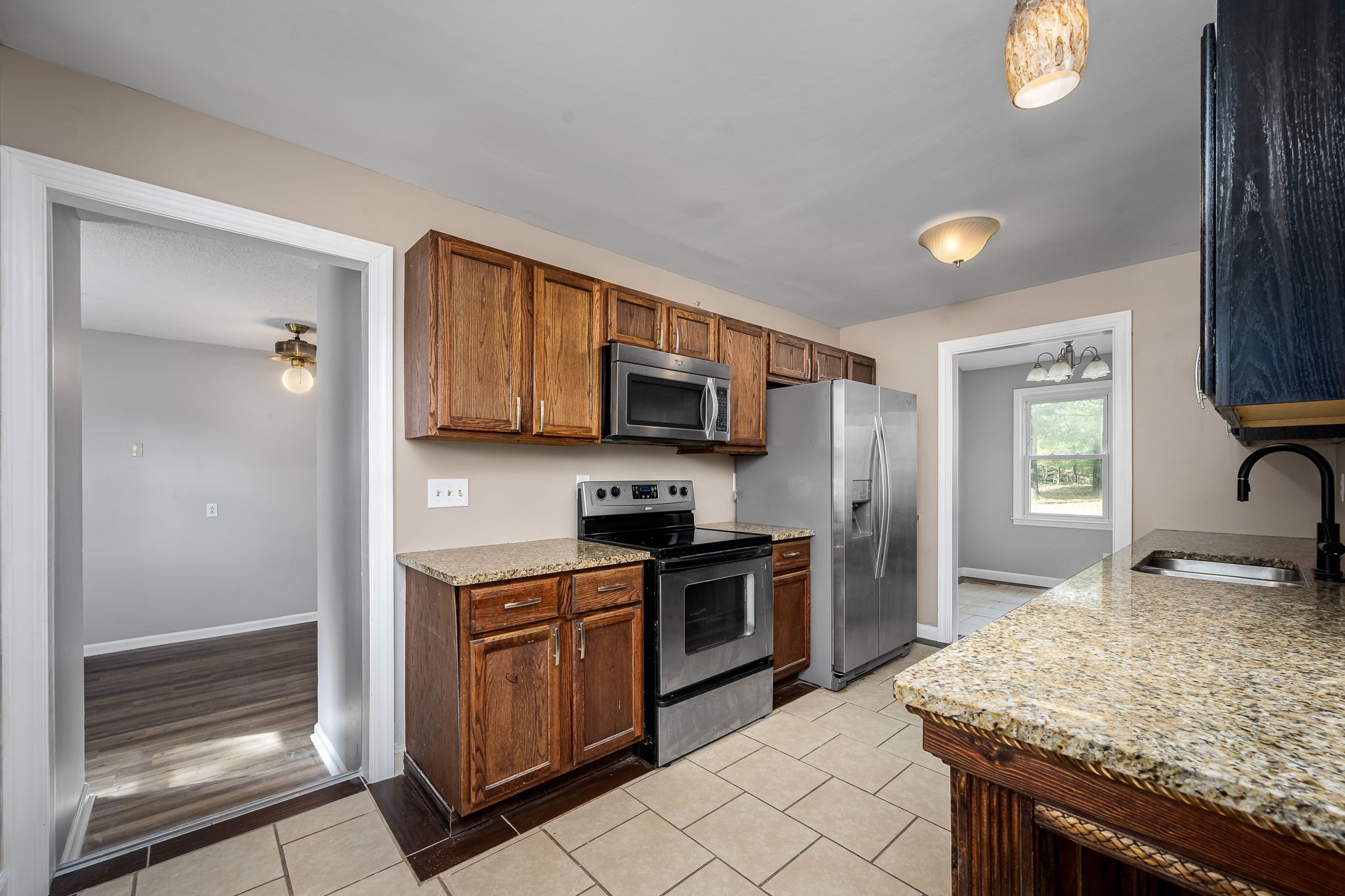 104 Dove Hollow Road Tullahoma, TN 37388 - Photo 15 of 37 a kitchen with stainless steel appliances granite countertop a stove microwave and sink