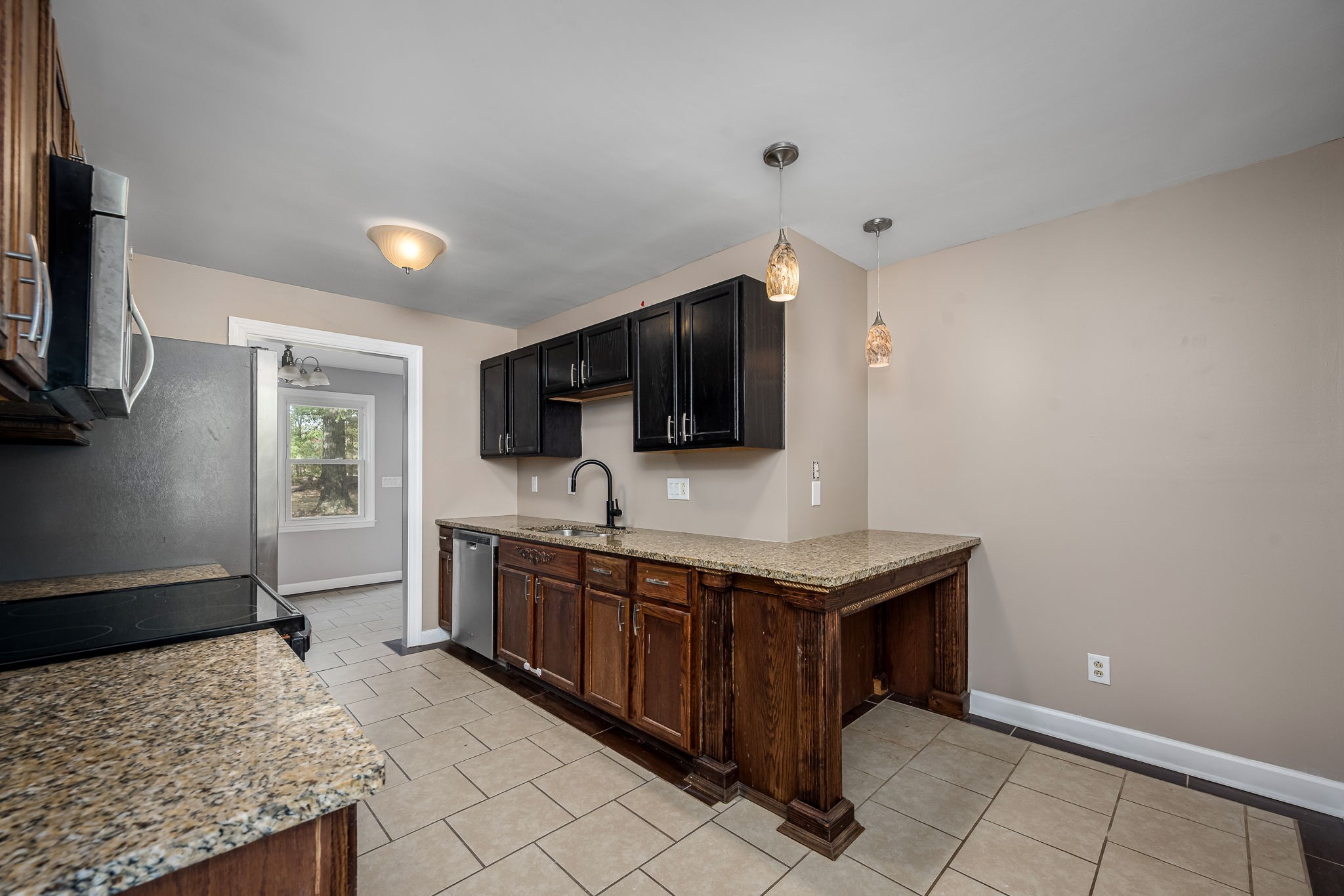 104 Dove Hollow Road Tullahoma, TN 37388 - Photo 16 of 37 a kitchen with stainless steel appliances granite countertop a stove and a sink