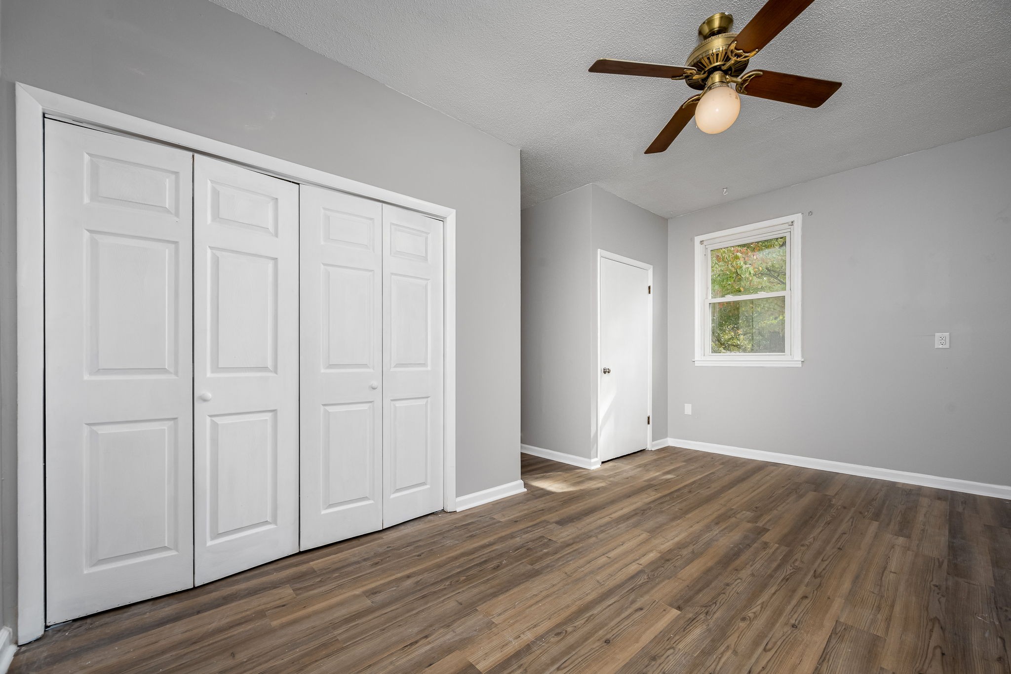104 Dove Hollow Road Tullahoma, TN 37388 - Photo 18 of 37 a view of an empty room with wooden floor and a ceiling fan