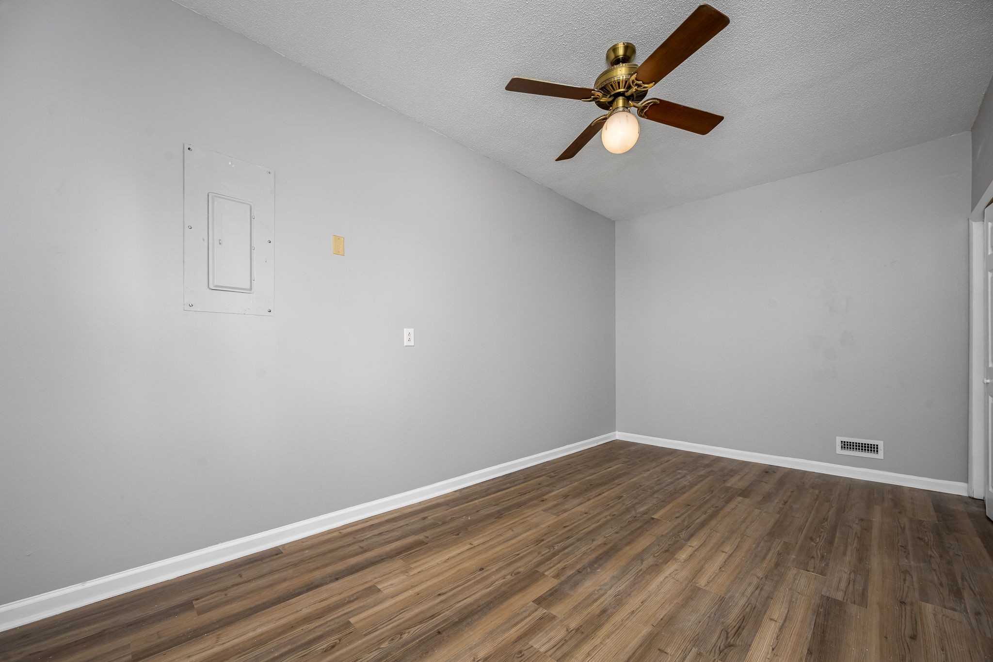 104 Dove Hollow Road Tullahoma, TN 37388 - Photo 19 of 37 a view of an empty room with wooden floor and a ceiling fan