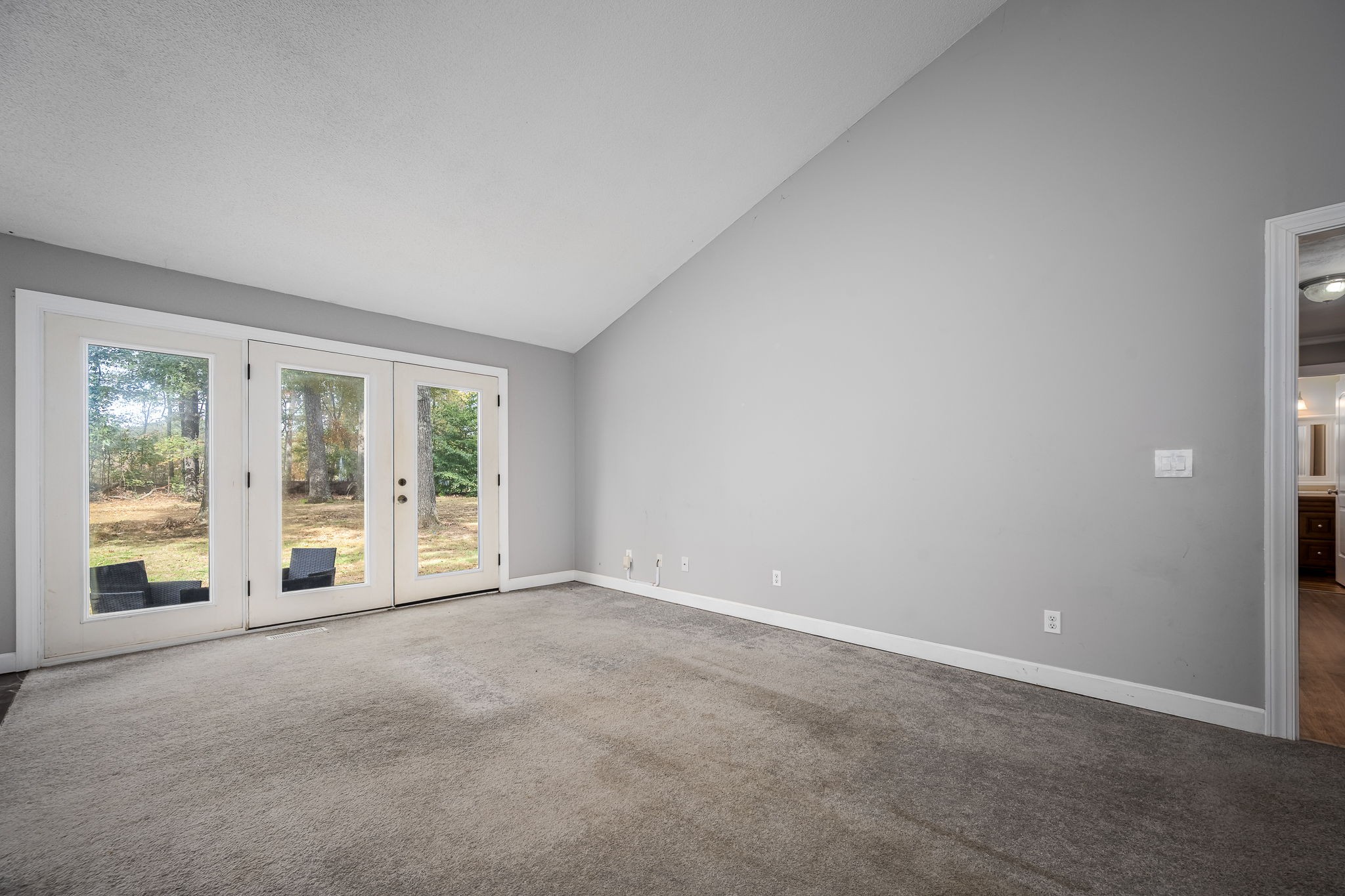 104 Dove Hollow Road Tullahoma, TN 37388 - Photo 10 of 37 an empty room with floor to ceiling window and an outdoor view