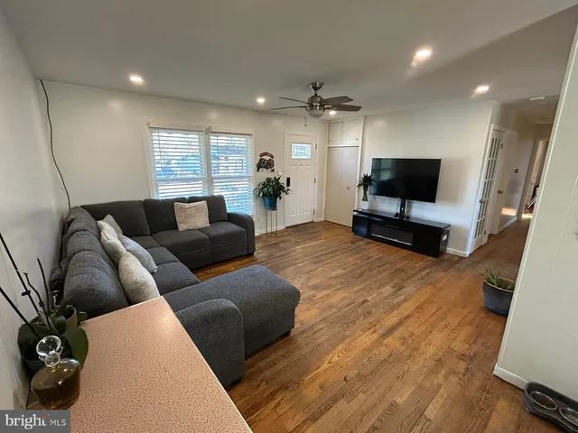 a bedroom with a bed and a flat tv screen on the dresser