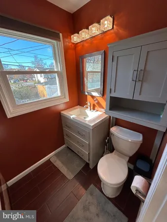 an empty room with wooden floor and sliding door