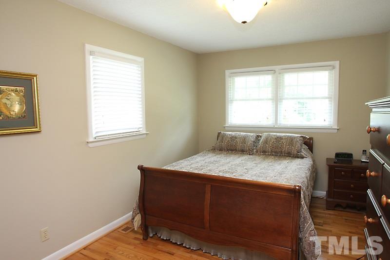 1019 Legend Road Raleigh, NC 27603 - Photo 8 of 12 a bedroom with a bed and a window