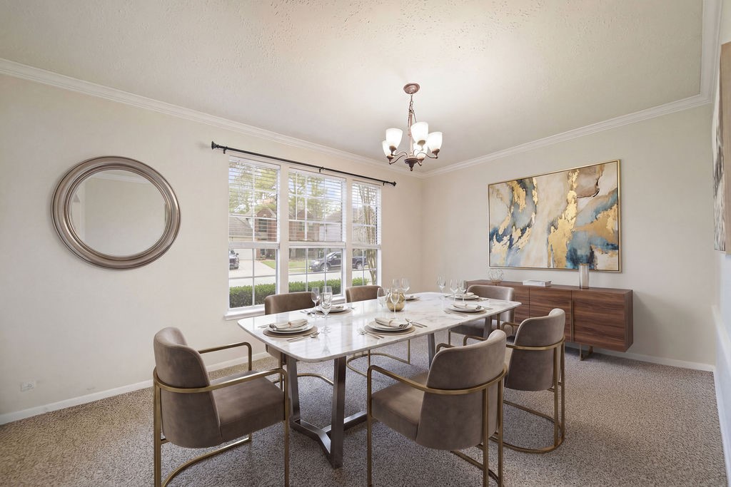 16114 Kintyre Point Road Houston, TX 77095 - Photo 11 of 44 A bright dining room featuring a large window, elegant chandelier, and a sleek marble table with modern chairs. The room is tastefully decorated with a round mirror and abstract art, creating a stylish and inviting atmosphere.