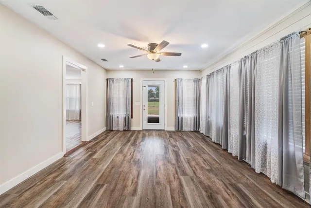 a view of wooden floor and windows in a room