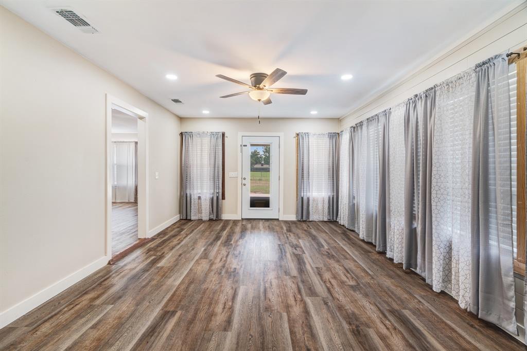 201 Farm To Market 906 Powderly, TX 75473 - Photo 16 of 32 a view of wooden floor and windows in a room