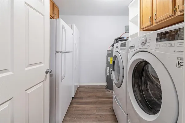 a view of a hallway with washer and dryer
