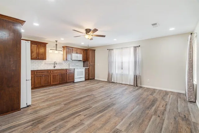 a view of a kitchen with a sink and a refrigerator