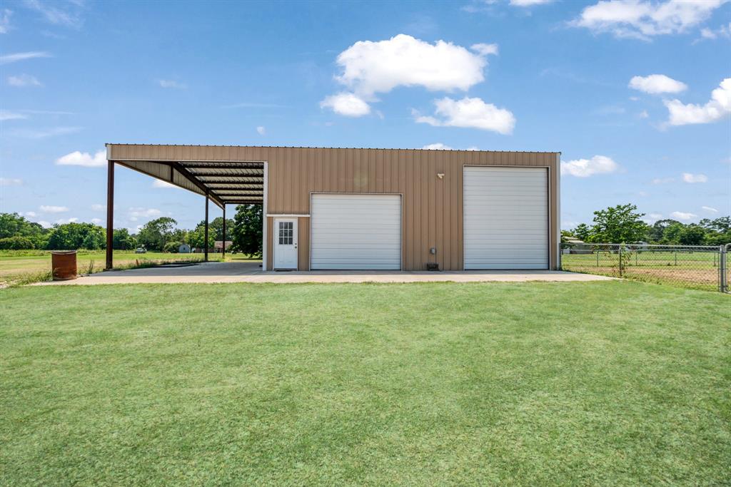 201 Farm To Market 906 Powderly, TX 75473 - Photo 28 of 32 a view of a house with backyard and a garden