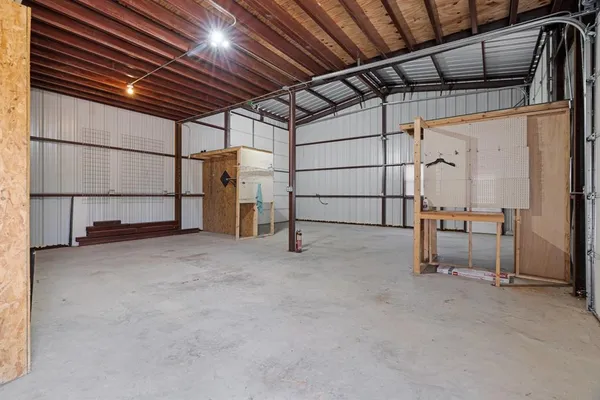 a view of empty room with wooden ceiling
